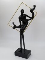 Man sitting on gold frame decor piece